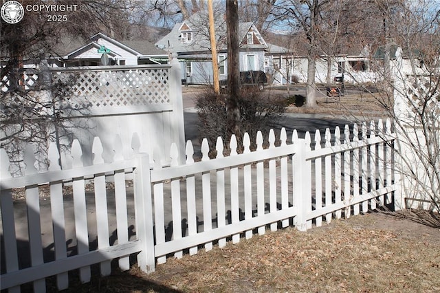 view of yard with a fenced front yard and a gate