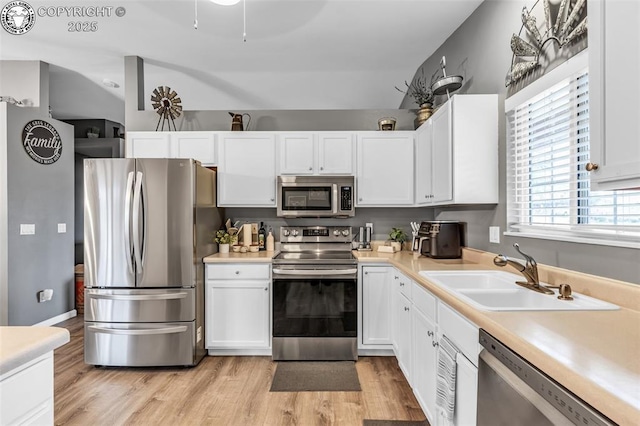 3065 Pear St, Canon City, CO 81212 - kitchen with stainless steel appliances, a sink, white cabinets, and light wood-type flooring