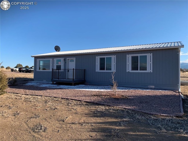 view of front of home with crawl space and metal roof