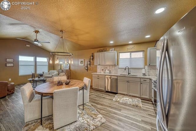 336 Arrowhead Dr, Florence, CO 81226 - kitchen with stainless steel appliances, a sink, a textured ceiling, light wood finished floors, and light countertops