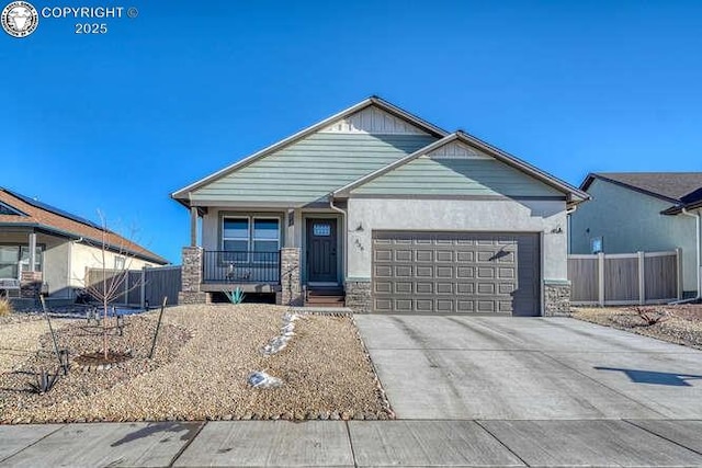 336 Arrowhead Dr, Florence, CO 81226 - ranch-style house featuring an attached garage, stone siding, driveway, stucco siding, and covered porch