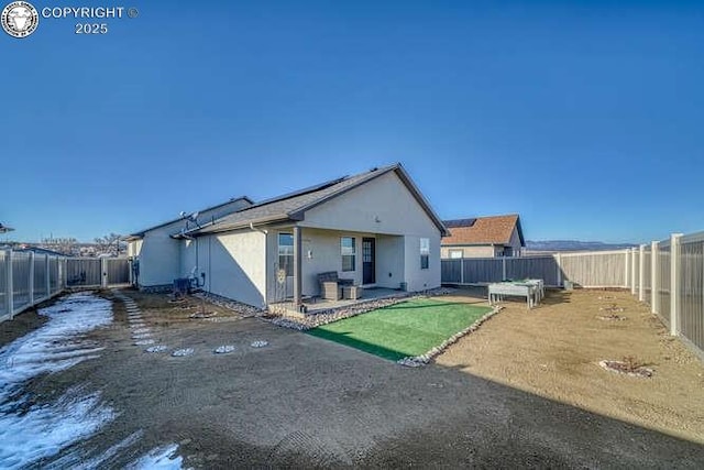 336 Arrowhead Dr, Florence, CO 81226 - rear view of property with stucco siding, a fenced backyard, and a patio area