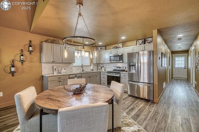 336 Arrowhead Dr, Florence, CO 81226 - dining area with light wood-style floors, baseboards, a textured ceiling, and recessed lighting