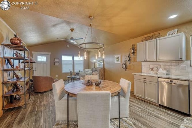 336 Arrowhead Dr, Florence, CO 81226 - dining area featuring light wood-style flooring, a ceiling fan, vaulted ceiling, recessed lighting, and a textured ceiling