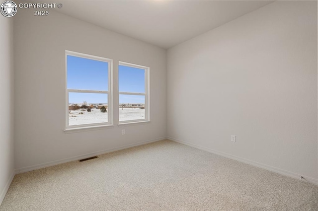 carpeted spare room with baseboards and visible vents