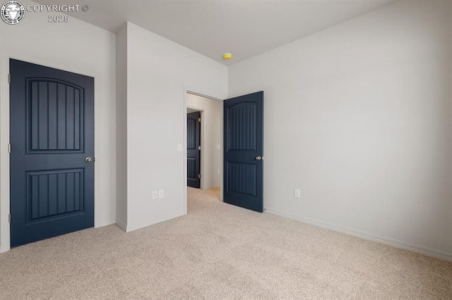 unfurnished bedroom featuring carpet floors and baseboards