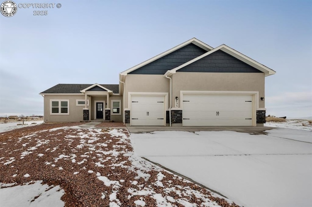 view of front of home featuring a garage, stone siding, and stucco siding