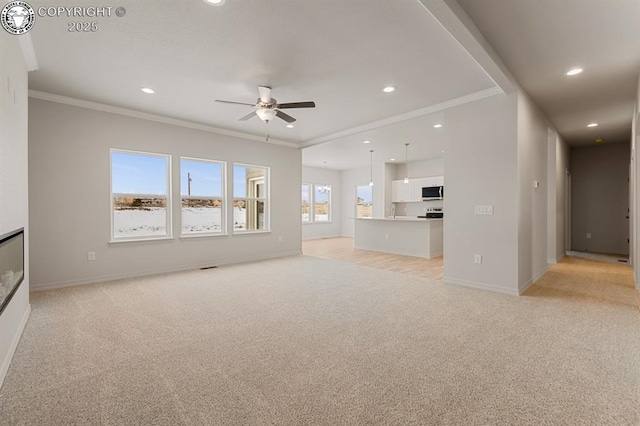 unfurnished living room featuring ornamental molding, recessed lighting, light carpet, and baseboards