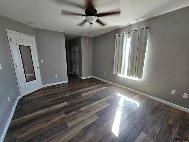 spare room featuring dark hardwood / wood-style floors and ceiling fan