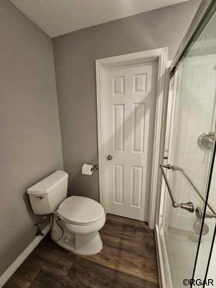 bathroom featuring wood-type flooring and toilet