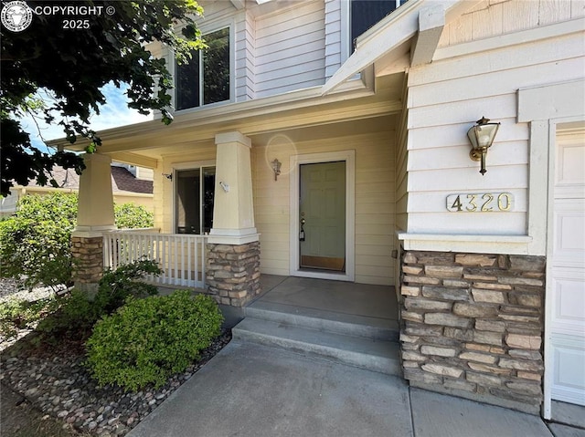 4320 Range Creek Dr, Colorado Springs, CO 80922 - property entrance featuring stone siding and a porch