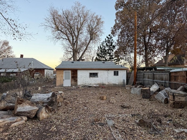 view of back house at dusk