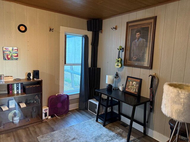 living area with wood walls, dark hardwood / wood-style floors, and wooden ceiling