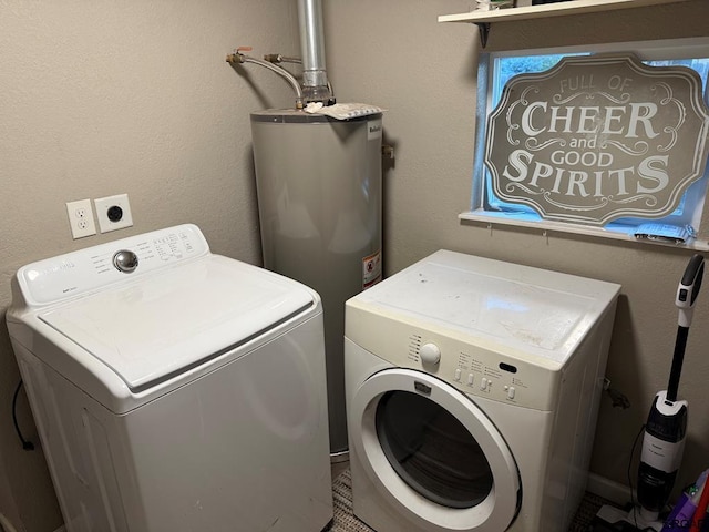 laundry area featuring water heater and washing machine and clothes dryer