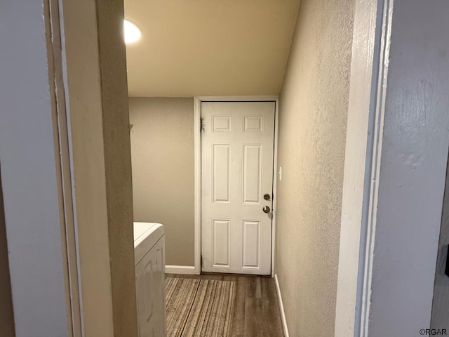 interior space with independent washer and dryer and dark hardwood / wood-style floors