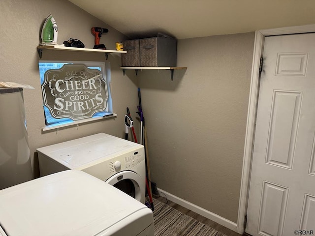 clothes washing area featuring hardwood / wood-style floors and washing machine and dryer