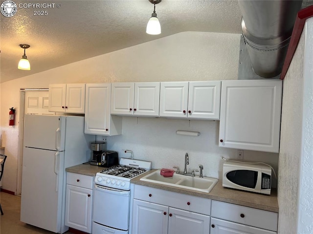 5105 Electric Ave, Westcliffe, CO 81252 - kitchen with vaulted ceiling, white appliances, a sink, white cabinetry, and a textured ceiling