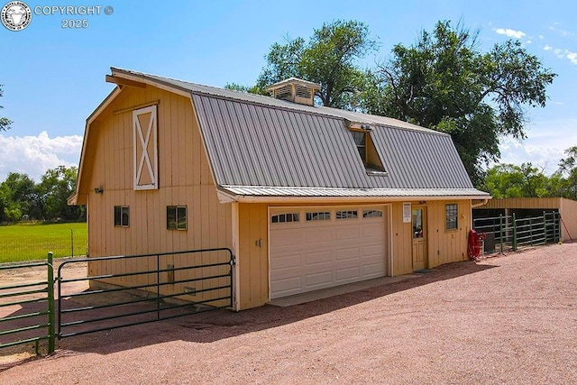 garage featuring a detached garage and fence