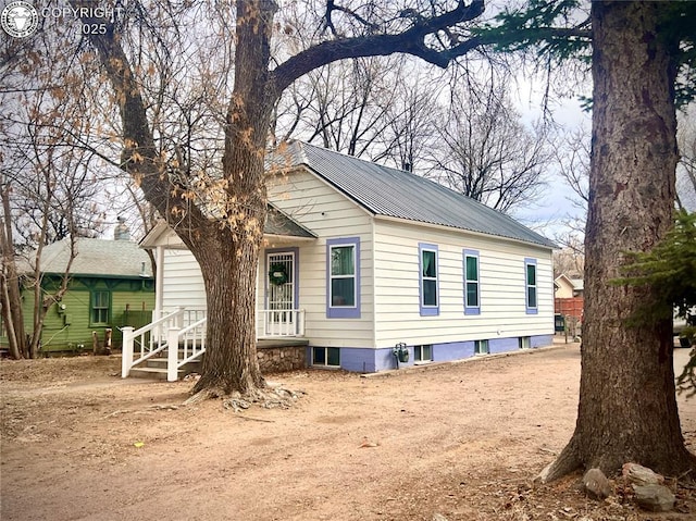 view of side of home with metal roof