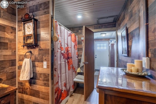 bathroom featuring wood-type flooring, wood ceiling, and wooden walls