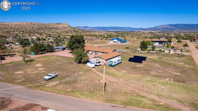 birds eye view of property with a mountain view