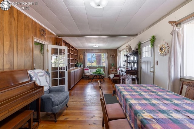 dining space featuring dark hardwood / wood-style floors and wood walls