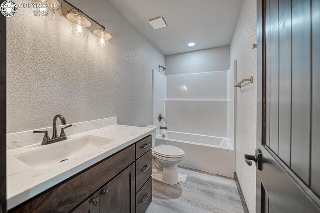 306 Fox Run E, Silver Cliff, CO 81252 - bathroom with a textured wall, wood finished floors, vanity, and bathing tub / shower combination
