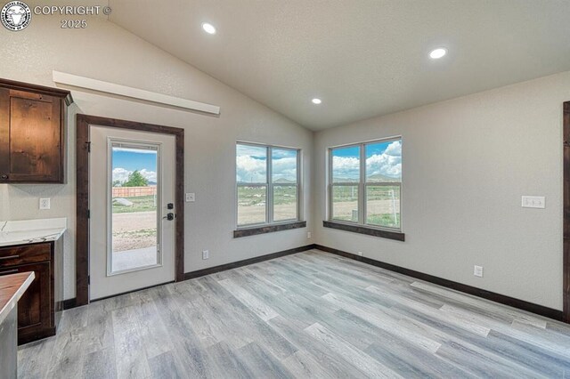 306 Fox Run E, Silver Cliff, CO 81252 - unfurnished dining area with lofted ceiling, light wood finished floors, and recessed lighting