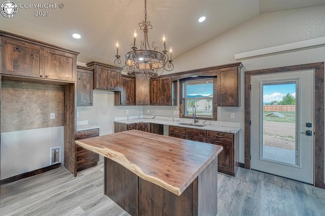 306 Fox Run E, Silver Cliff, CO 81252 - kitchen with vaulted ceiling, butcher block countertops, a chandelier, light wood-style flooring, and plenty of natural light