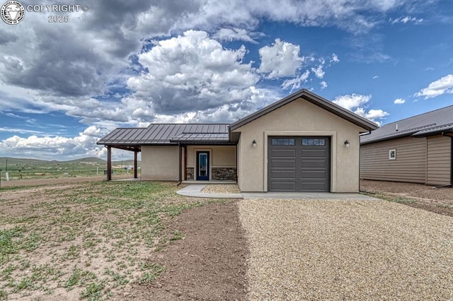 306 Fox Run E, Silver Cliff, CO 81252 - ranch-style home featuring stucco siding, driveway, a standing seam roof, a garage, and a metal roof