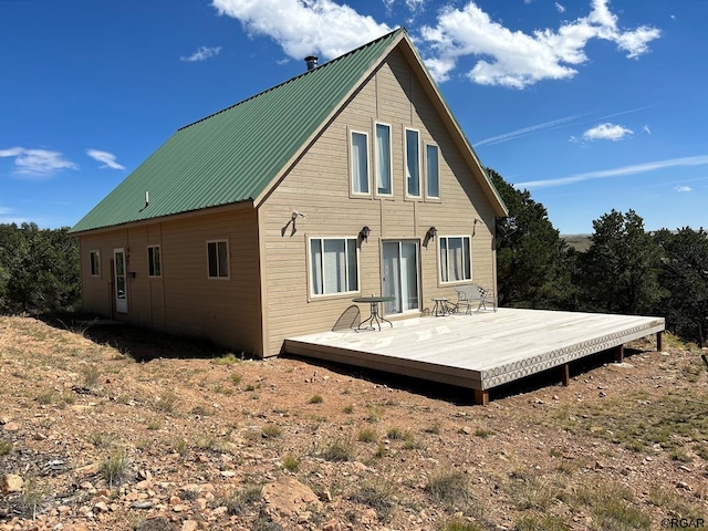 rear view of property featuring a wooden deck