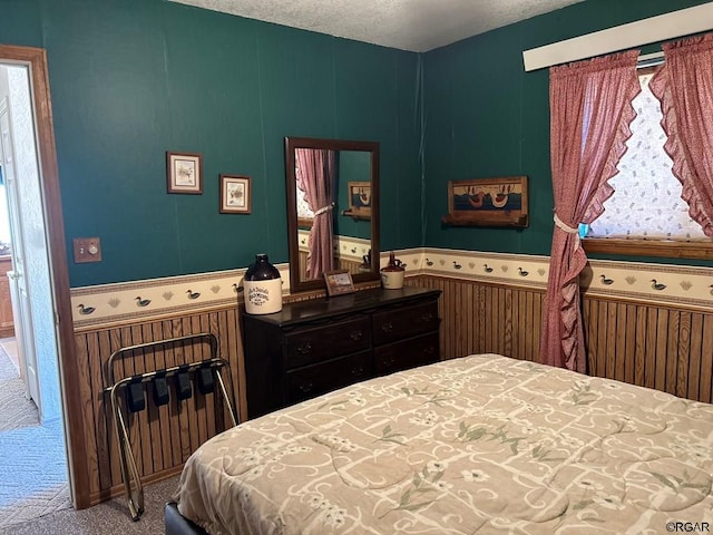 carpeted bedroom with a textured ceiling