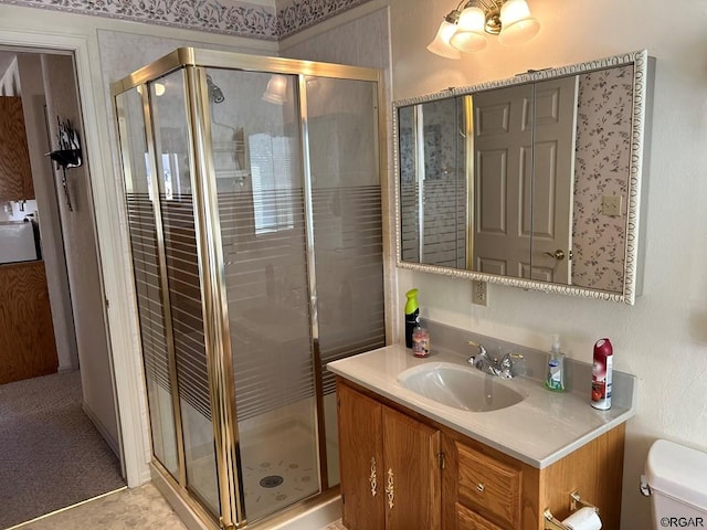 bathroom with an enclosed shower, vanity, and toilet