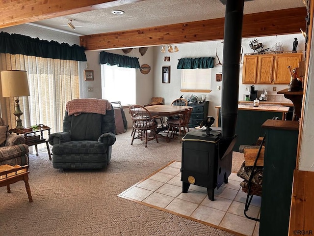 carpeted living room with a textured ceiling and a wood stove