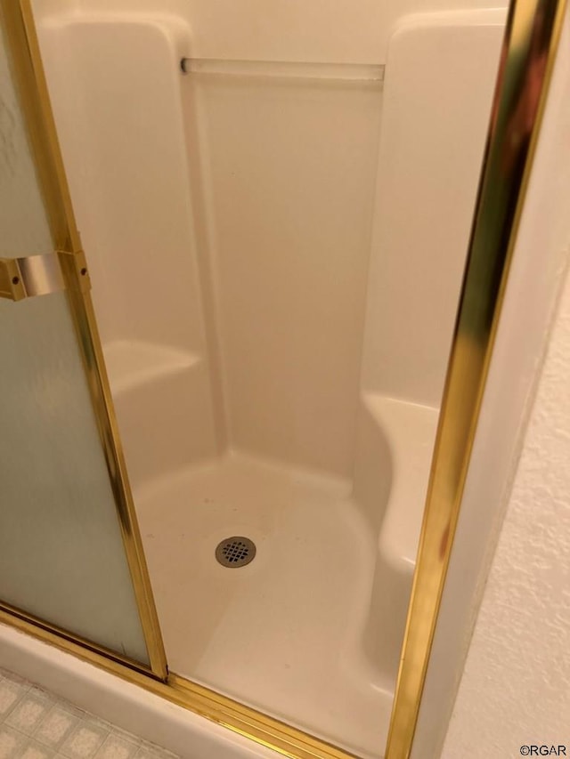 bathroom with a shower with shower door