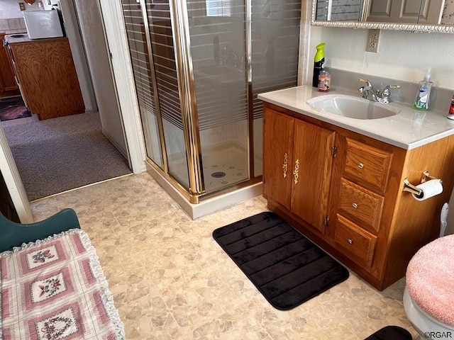 bathroom with vanity, toilet, and walk in shower