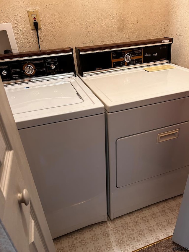 clothes washing area with washer and clothes dryer