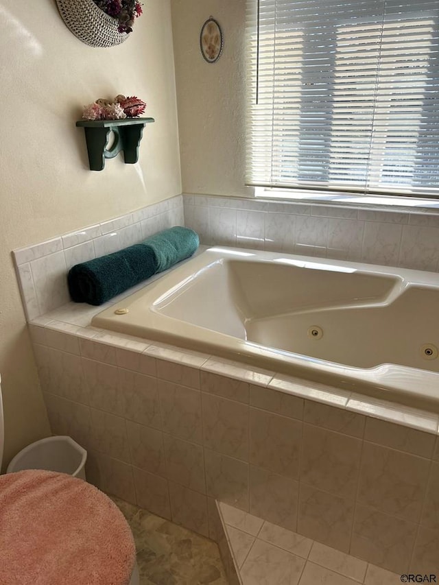 bathroom featuring tile patterned floors and tiled bath