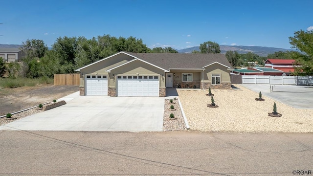 ranch-style home featuring a mountain view and a garage