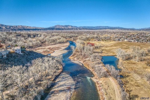 birds eye view of property with a water and mountain view