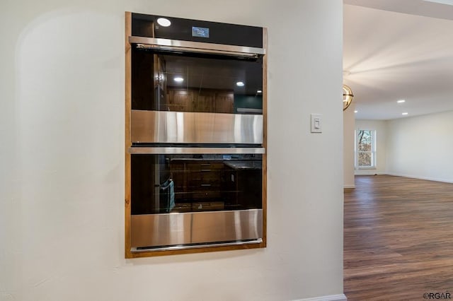 interior details featuring wood-type flooring and double oven