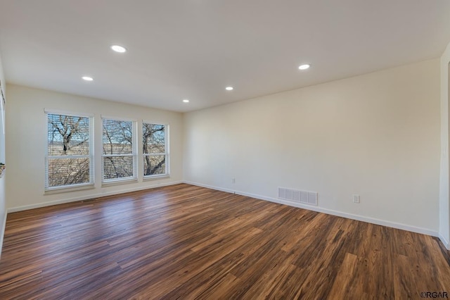 unfurnished room with dark wood-type flooring