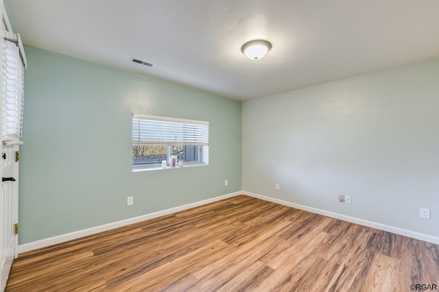 unfurnished room featuring wood-type flooring