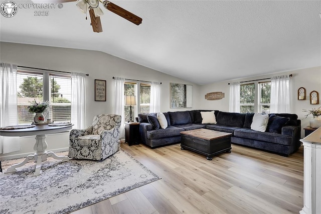 1431 Pine St, Canon City, CO 81212 - living area featuring vaulted ceiling, healthy amount of natural light, a ceiling fan, and light wood-style flooring
