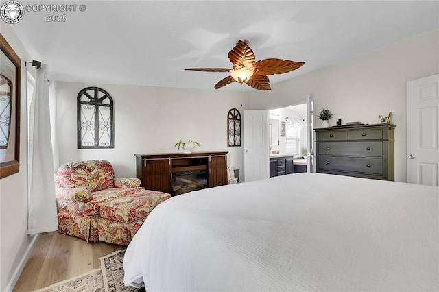 1431 Pine St, Canon City, CO 81212 - bedroom with wood finished floors, connected bathroom, and ceiling fan