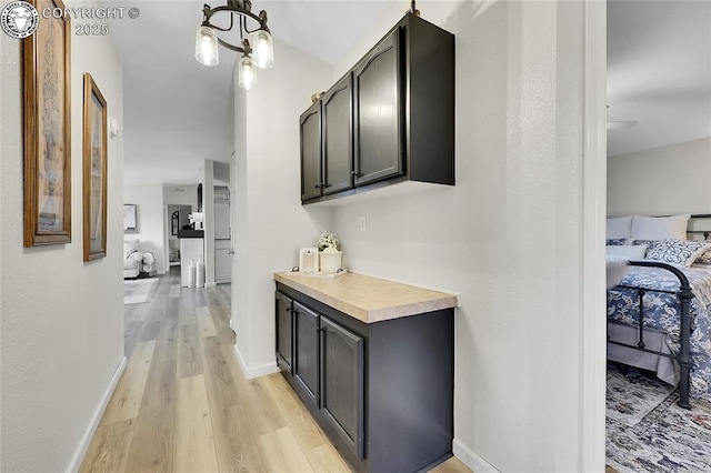 1431 Pine St, Canon City, CO 81212 - corridor with light wood-style flooring and a chandelier