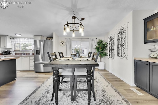 1431 Pine St, Canon City, CO 81212 - dining area with light wood finished floors and a chandelier