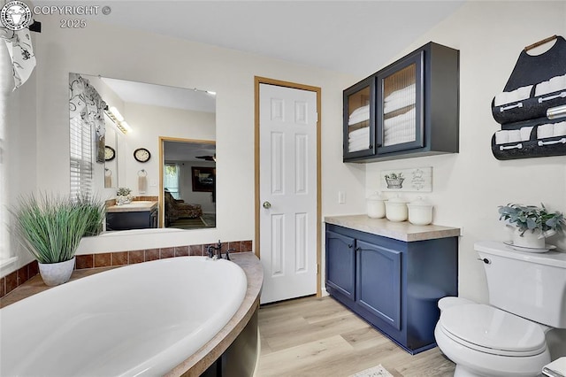 1431 Pine St, Canon City, CO 81212 - bathroom with a garden tub, wood finished floors, vanity, and ensuite bath