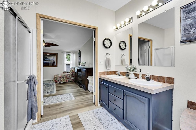 1431 Pine St, Canon City, CO 81212 - full bathroom with double vanity, wood finished floors, connected bathroom, and a ceiling fan