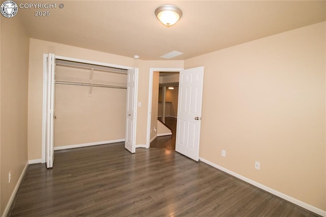 7465 Sun Prairie Dr, Colorado Springs, CO 80925 - unfurnished bedroom featuring dark wood-style floors and a closet
